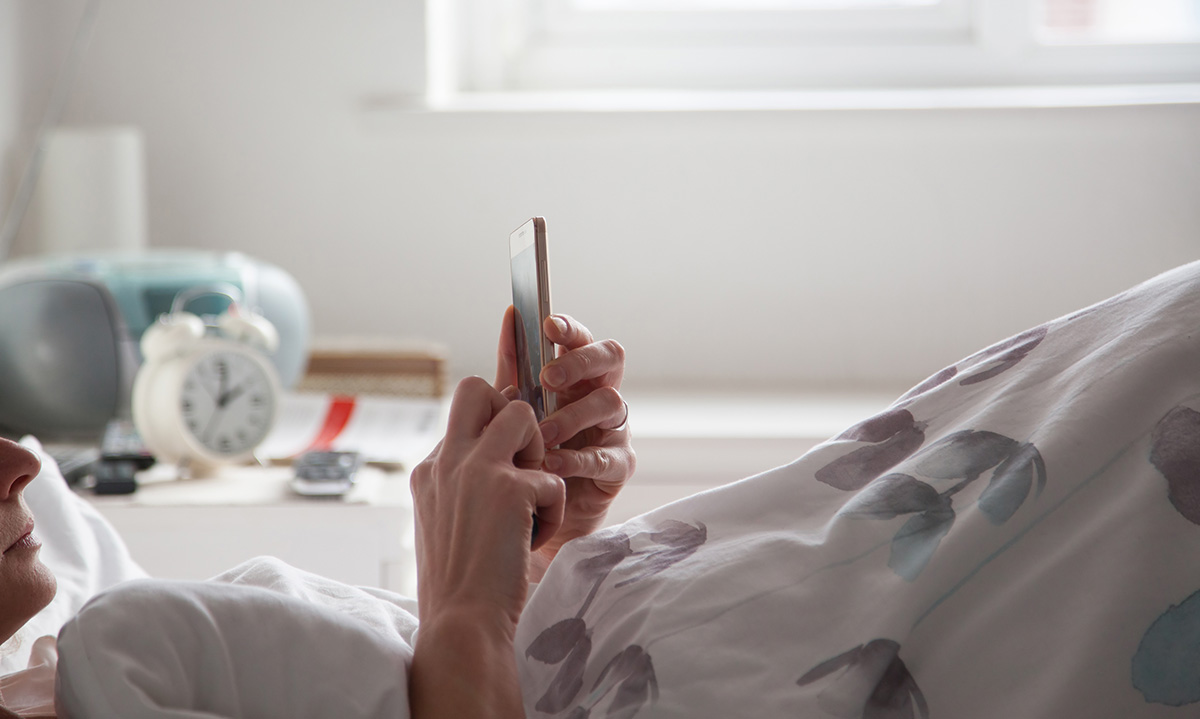 Woman,Using,Smartphone,In,Bed